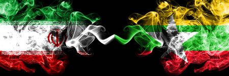 Iran vs Myanmar smoky mystic states flags placed side by side. Thick colored silky smokes flag combination of Iranian and Myanmarの写真素材