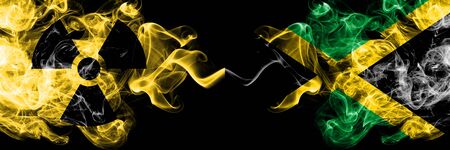 Jamaica, Jamaican vs nuclear smoky mystic flags placed side by side. Thick colored silky smokes combination of Jamaica, Jamaican flag and radioactive sign.の写真素材