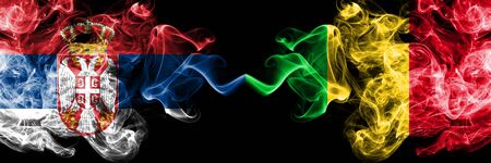Serbia vs Mali smoky mystic flags placed side by side. Thick colored silky smokes combination of Serbian and Mali flagの写真素材