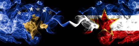 Kosovo vs Yugoslavia smoky mystic flags placed side by side. Thick colored silky smokes combination of Kosovo and Yugoslavia flagの写真素材