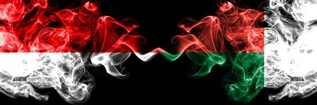 Indonesia vs Madagascar, Madagascan smoky mystic flags placed side by side. Thick colored silky smoke flags of Indonesia and Madagascar, Madagascanの写真素材