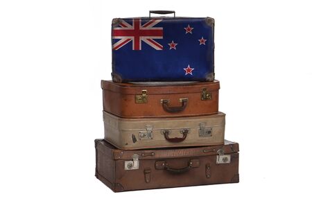 New Zealand, New Zealander travel concept. Group of vintage suitcases isolated on white backgroundの写真素材