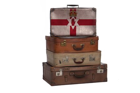 Northern Ireland travel concept. Group of vintage suitcases isolated on white backgroundの写真素材