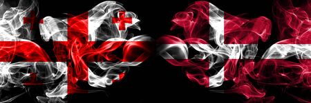 Georgia, Denmark competition thick colorful smoky flags. European football qualifications gamesの写真素材