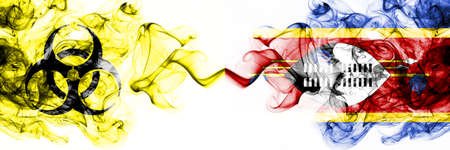 Swaziland, Swazi Quarantine. Coronavirus COVID-19 lockdown. Smoky mystic flag of Swaziland, Swazi with biohazard symbol placed side by side.の写真素材