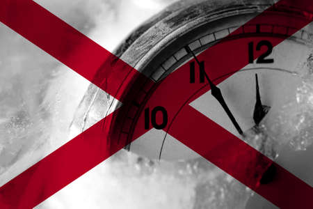 Alabama, Alabamian flag with clock close to midnight in the background. Happy New Year conceptの写真素材