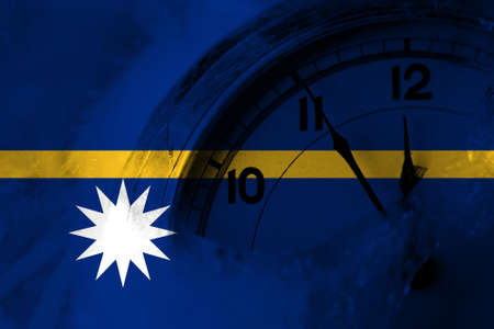 Nauru, Nauruan flag with clock close to midnight in the background. Happy New Year conceptの写真素材