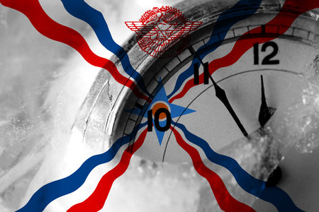 Assyria flag with clock close to midnight in the background. Happy New Year concept