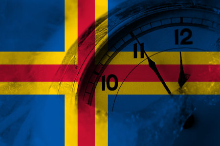 Aland, Alandic flag with clock close to midnight in the background. Happy New Year concept