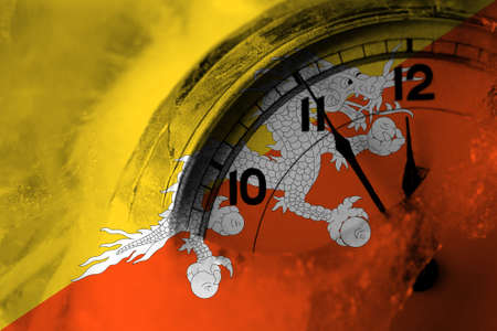 Bhutan, Bhutanese flag with clock close to midnight in the background. Happy New Year conceptの写真素材
