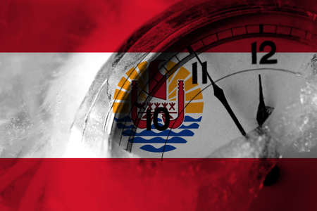France, French Polynesia flag with clock close to midnight in the background. Happy New Year conceptの写真素材
