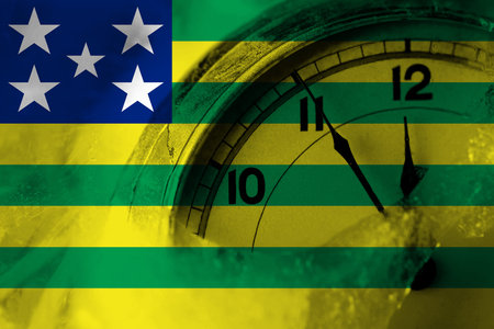 Brazil, Brazilian, Goias flag with clock close to midnight in the background. Happy New Year conceptの写真素材