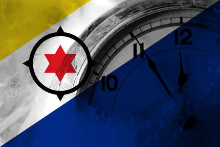 Netherlands, Dutch, Holland, Bonaire flag with clock close to midnight in the background. Happy New Year conceptの写真素材