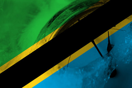 Tanzania flag with clock close to midnight in the background. Happy New Year conceptの写真素材