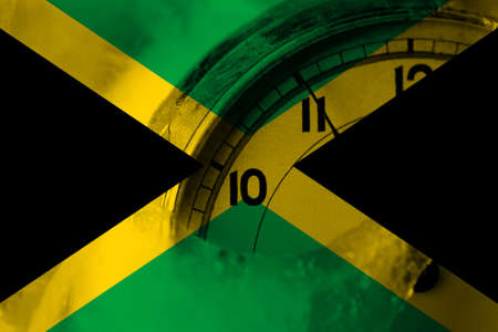 Jamaica, Jamaican flag with clock close to midnight in the background. Happy New Year conceptの写真素材