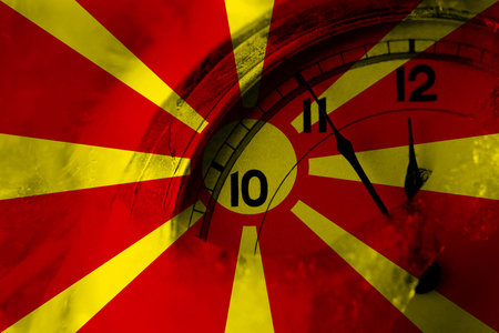 Macedonia, Macedonian flag with clock close to midnight in the background. Happy New Year conceptの写真素材