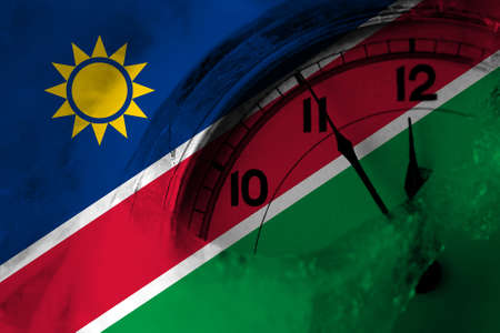Namibia, Namibian flag with clock close to midnight in the background. Happy New Year conceptの写真素材