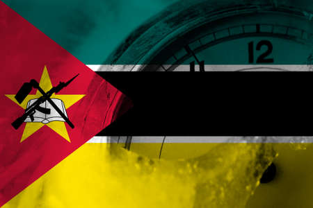 Mozambique, Mozambican flag with clock close to midnight in the background. Happy New Year conceptの写真素材