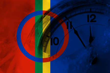 Sami flag with clock close to midnight in the background. Happy New Year conceptの写真素材