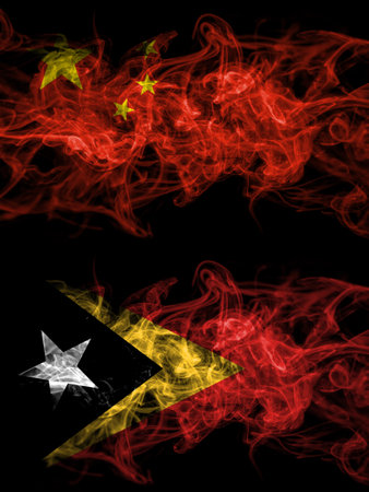 China, Chinese vs East Timor, Timorese smoky mystic flags placed side by side. Thick colored silky abstract smoke flags.の写真素材