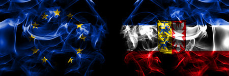 Flags of EU, European Union vs Germany Schleswig Holstein, state. Smoke flag placed side by side on black background.の写真素材