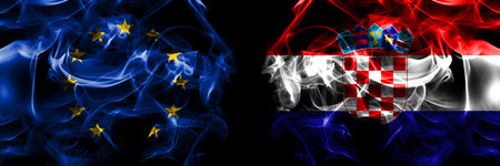 Flags of EU, European Union vs Croatia, Croatian. Smoke flag placed side by side on black background.の写真素材