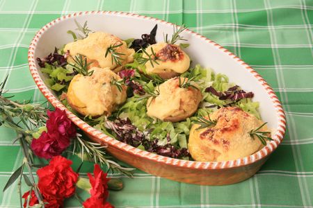 Baked potato halves with cheese in lettuceの写真素材