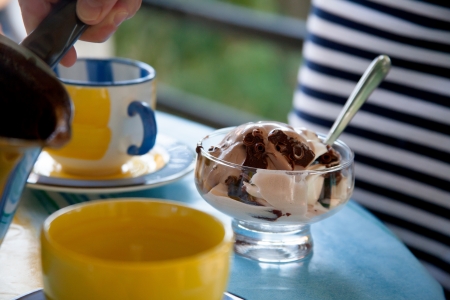 A cup of coffee and ice cream on the tableの写真素材