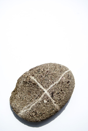 The stone with the sign x isolated on whiteの写真素材