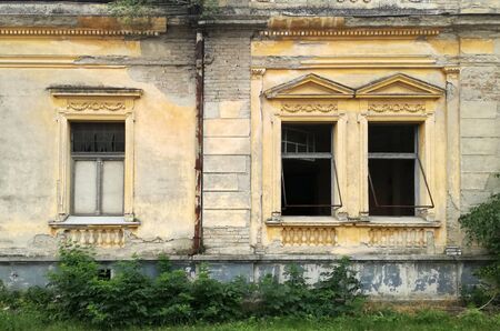 Three windows on the ruined facade of an old abandoned house in Mol, Backa, Serbiaの写真素材