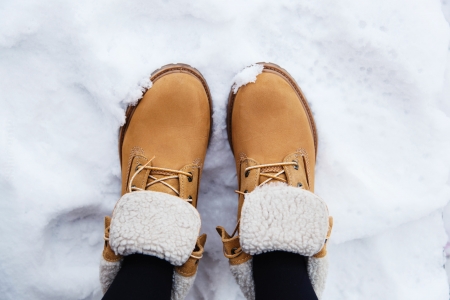 Pair brown boots in white fresh snowの写真素材