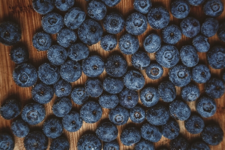 Fresh wet blueberry on wooden board, look from aboveの写真素材