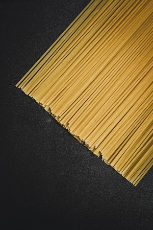 Raw spaghetti on black plate, look from aboveの写真素材