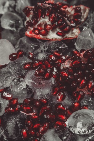 Chopped pomegranate with ice cubes, narrow depth of fieldの写真素材