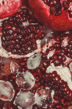 Chopped pomegranate with ice cubes, narrow depth of fieldの写真素材