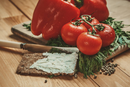 Tomatoes , bell pepper and dill on wooden tableの写真素材