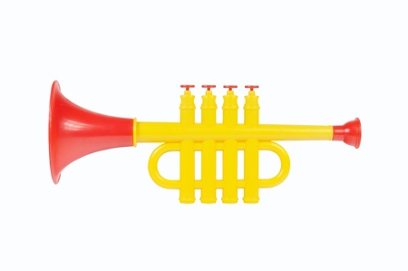 Children trumpet made of colored plastic against white backgroundの写真素材