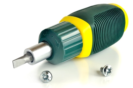 Reversible screwdriver and two screws on a light background の写真素材