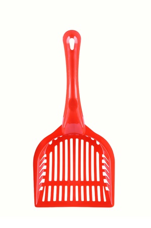 Red plastic scoop for kitty litter on a white backgroundの写真素材