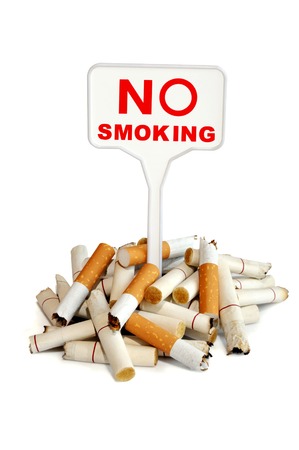 No smoking. A bunch of cigarette butts and prohibiting sign on a white backgroundの写真素材