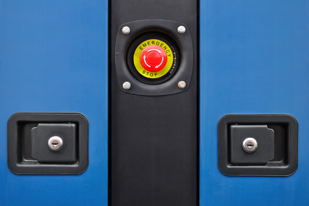 Button emergency power-off and fragments of blue panels with locksの写真素材