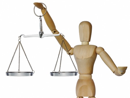 Wooden mannequin holds in his outstretched hand weights on a white backgroundの写真素材