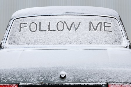 Covered with snow car with the inscription on the rear windowの写真素材