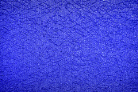 Fragment of blue fabric with abstract pattern as background