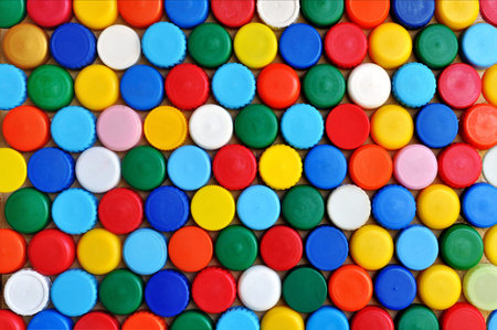 Abstract background made of colored plastic caps for bottles of drinks