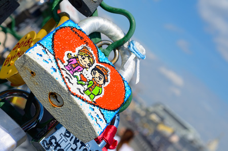 Moscow, Russia - June 25, 2015: Colored wedding lock with the image of a boy and a girl on Luzhkov Bridge in Moscow. Selective focus. Valentine's Day. Wedding's Day.のeditorial素材