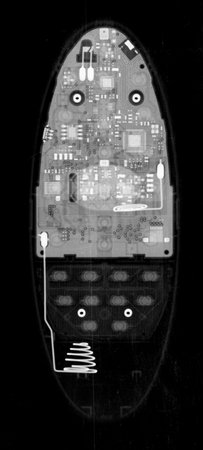 TV remote control under X-rays in negative. Visibility through. Image was obtained with real X-ray...