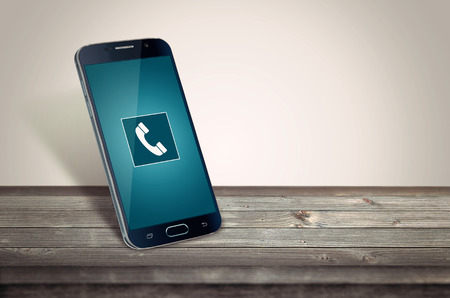 Smart phone on table calling mockupの写真素材