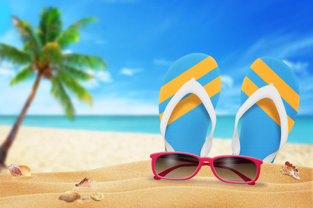 glasses and slippers on the beachの写真素材