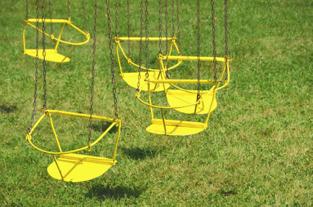 small children carousel with yellow chairs
